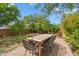 Inviting backyard patio with brick pavers, an outdoor dining set, and lush green landscaping at 4430 E Creosote Dr, Cave Creek, AZ 85331