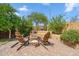 Relaxing backyard with built-in seating, fire pit, desert landscaping, and privacy wall at 4430 E Creosote Dr, Cave Creek, AZ 85331