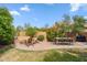 A landscaped backyard with a brick paver patio, a fire pit, outdoor furniture, and mature landscaping at 4430 E Creosote Dr, Cave Creek, AZ 85331