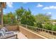 Outdoor balcony features wrought iron railing and seating with views of mature trees at 4430 E Creosote Dr, Cave Creek, AZ 85331