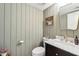 Stylish powder room features gray paneled walls and a marble topped vanity with brass faucet at 4430 E Creosote Dr, Cave Creek, AZ 85331
