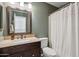 Bathroom features a dark wood vanity with granite countertop and shower with curtain at 4430 E Creosote Dr, Cave Creek, AZ 85331