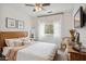 Bright bedroom with ceiling fan, white bedding, curated decor, and large window at 4430 E Creosote Dr, Cave Creek, AZ 85331
