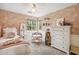 Charming bedroom with pink floral wallpaper, neutral carpet and white trim. A table is setup in the corner at 4430 E Creosote Dr, Cave Creek, AZ 85331