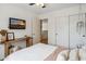 Comfortable bedroom with mounted TV, desk, and closet with sliding doors at 4430 E Creosote Dr, Cave Creek, AZ 85331