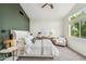 Bright bedroom with green accent wall, plush carpet, and large windows providing plenty of natural light at 4430 E Creosote Dr, Cave Creek, AZ 85331