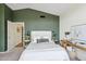 Spacious bedroom features green accent wall, an open door to another room, and neutral colored carpet at 4430 E Creosote Dr, Cave Creek, AZ 85331