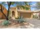 Front exterior of the desert home features a tile roof, mature landscaping, and a two-car garage at 4430 E Creosote Dr, Cave Creek, AZ 85331