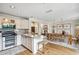 Open-concept kitchen with stainless steel appliances, marble counters, and seamless transition to the dining and living areas at 4430 E Creosote Dr, Cave Creek, AZ 85331