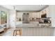 Bright kitchen features marble counters, stainless appliances, and a charming breakfast bar with seating at 4430 E Creosote Dr, Cave Creek, AZ 85331