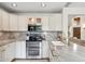 Well-equipped kitchen featuring stainless steel appliances, marble countertops, and sleek white cabinetry at 4430 E Creosote Dr, Cave Creek, AZ 85331