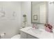 Stylish powder bathroom features modern fixtures, white vanity, and a decorative mirror, creating a serene and inviting space at 4637 S Jetty --, Mesa, AZ 85212