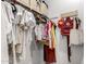 Functional walk-in closet with organized storage, hangers, and a variety of bags, providing practical space at 4637 S Jetty --, Mesa, AZ 85212