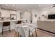 A dining area adjacent to the kitchen features a glass table set for four, adding elegance to the open-concept living space at 4637 S Jetty --, Mesa, AZ 85212