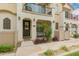 Inviting townhome facade with private porch, balcony, and desert landscaping at 4637 S Jetty --, Mesa, AZ 85212