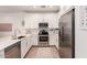 Bright kitchen features stainless steel appliances, ample white cabinetry, quartz countertops, and stainless steel appliances at 4637 S Jetty --, Mesa, AZ 85212