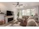 Cozy living room with fireplace, comfortable sectional sofa, and plenty of natural light at 4637 S Jetty --, Mesa, AZ 85212