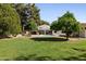 Lush backyard featuring pool, patio, and mature citrus trees at 5202 E Larkspur Dr, Scottsdale, AZ 85254