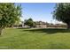 Sprawling backyard with lush green grass, pool and pool house at 5202 E Larkspur Dr, Scottsdale, AZ 85254