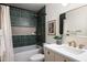 Elegant bathroom featuring green tiled shower and brass fixtures, offering a luxurious and stylish bathing experience at 5202 E Larkspur Dr, Scottsdale, AZ 85254