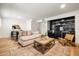 Spacious living room with a comfortable sofa, wet bar, and accent rug, perfect for relaxation and entertaining at 5202 E Larkspur Dr, Scottsdale, AZ 85254