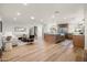 Spacious open-concept living room with hardwood flooring seamlessly connecting living, dining, and kitchen at 5202 E Larkspur Dr, Scottsdale, AZ 85254