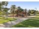 Community playground with shade structure, multiple slides, and swings on manicured lawns at 5202 E Larkspur Dr, Scottsdale, AZ 85254