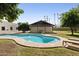 Backyard swimming pool area with grass yard and pool house at 5202 E Larkspur Dr, Scottsdale, AZ 85254