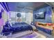 Stylish bedroom featuring a unique accent wall with a fireplace and modern chandelier lighting at 535 W Thomas Rd # 513, Phoenix, AZ 85013