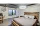 Modern bedroom featuring a wood frame bed, large window view and unique chandelier at 535 W Thomas Rd # 513, Phoenix, AZ 85013