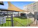 Enclosed dog park with green space, shade cover, and a convenient waste disposal station at 535 W Thomas Rd # 513, Phoenix, AZ 85013
