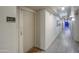 Well lit hallway with apartment entrances, tile floors, and a view of the far end at 535 W Thomas Rd # 513, Phoenix, AZ 85013