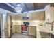 Contemporary kitchen with stainless steel appliances, stylish cabinetry, and gray tile flooring at 535 W Thomas Rd # 513, Phoenix, AZ 85013