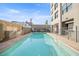 Inviting outdoor pool with lounge chairs and privacy fence, perfect for relaxation and recreation at 535 W Thomas Rd # 513, Phoenix, AZ 85013