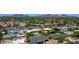Expansive aerial view of a community with mature trees and mountain views in the distance at 5441 E Wethersfield Rd, Scottsdale, AZ 85254