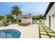 Stunning backyard featuring a sparkling pool, outdoor kitchen, dining, and meticulously maintained landscaping at 5441 E Wethersfield Rd, Scottsdale, AZ 85254