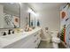 Bright bathroom with double sinks, trendy black fixtures, and a shower with fun, funky curtain at 5441 E Wethersfield Rd, Scottsdale, AZ 85254