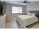 Bedroom with stylish striped quilt and a large flatscreen TV at 5441 E Wethersfield Rd, Scottsdale, AZ 85254