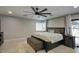 Spacious bedroom featuring a queen-sized bed, ceiling fan, and access to the backyard at 5441 E Wethersfield Rd, Scottsdale, AZ 85254