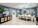 Elegant dining room with a large table, seating for eight, and stylish decor at 5441 E Wethersfield Rd, Scottsdale, AZ 85254