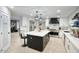 Open-concept kitchen with a central island, sleek appliances, and pantry for ample storage at 5441 E Wethersfield Rd, Scottsdale, AZ 85254