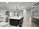 Bright kitchen with a large central island, barstool seating, and updated appliances at 5441 E Wethersfield Rd, Scottsdale, AZ 85254