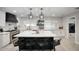 Modern kitchen featuring a large island with seating, white countertops, and stainless steel appliances at 5441 E Wethersfield Rd, Scottsdale, AZ 85254