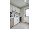 Stylish kitchenette with white cabinets, stainless steel appliances, and sleek countertops at 5441 E Wethersfield Rd, Scottsdale, AZ 85254