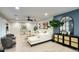 Comfortable living room showcases an elegant white sofa, decorative furniture, and a large window for natural light at 5441 E Wethersfield Rd, Scottsdale, AZ 85254