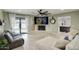 Cozy living room with a fireplace, large sectional, and access to the outdoor pool area at 5441 E Wethersfield Rd, Scottsdale, AZ 85254