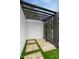 Modern outdoor shower featuring black hardware, concrete floors, and lush greenery, perfect for rinsing off after a swim at 5441 E Wethersfield Rd, Scottsdale, AZ 85254