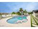 Sparkling pool area with poolside loungers, landscaping, and covered outdoor kitchen and dining area at 5441 E Wethersfield Rd, Scottsdale, AZ 85254