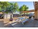 Spacious backyard with a gravel area, a shed, patio furniture, and a fire pit at 5529 W Villa Maria Dr, Glendale, AZ 85308