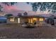 An inviting backyard with desert landscaping featuring a covered patio with comfortable seating at 5529 W Villa Maria Dr, Glendale, AZ 85308